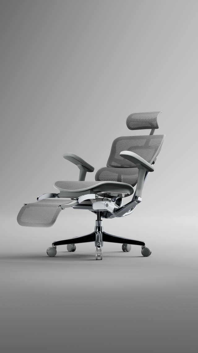 Grey mesh, grey frame Ergohuman office chair in a grey studio space reclining with the footrest opening. 