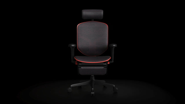 Red Enjoy Ultra gaming chair facing towards the camera in a black studio space. It has a headrest and footrest.