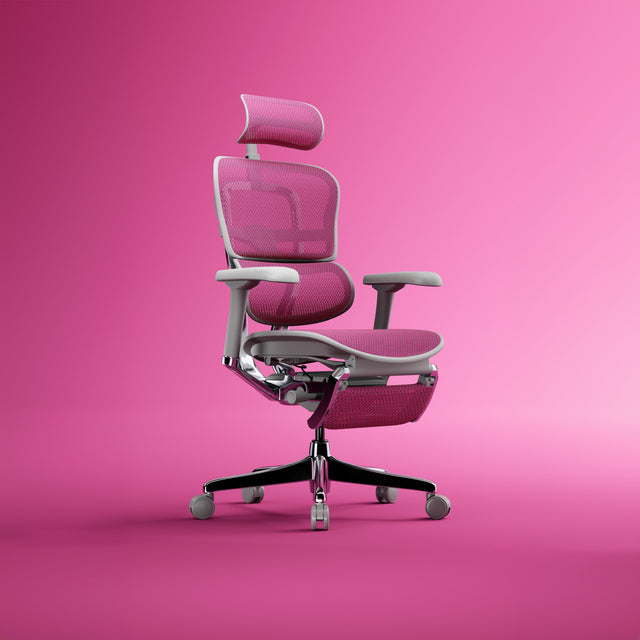 Pink office chair with grey frame. Ergohuman Elite with headrest and legrest. Positioned 45-degrees to the right in a pink studio space. 