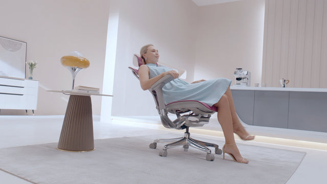 Teaser video for the Mirus Elite office chair. A woman in a blue dress adjusts the chair and hugs her child on the chair. 